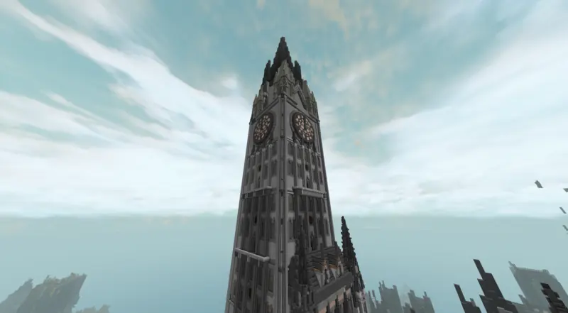 a tall gothic stone tower with two clock faces against a bright sky